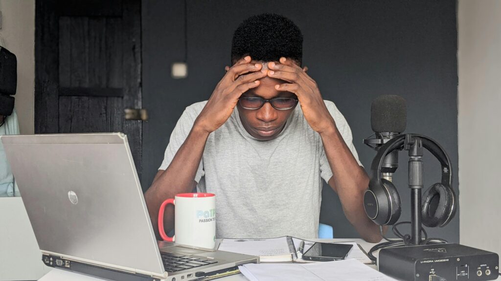 A worried employee that needs boosting by the management at his desk.
